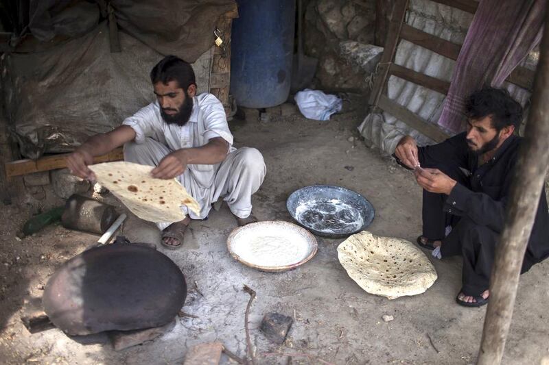 A miner cooks roti after finishing his shift at a coal mine in Punjab, where nearly 60 per cent of Pakistan's working children are found. Sara Farid / Reuters