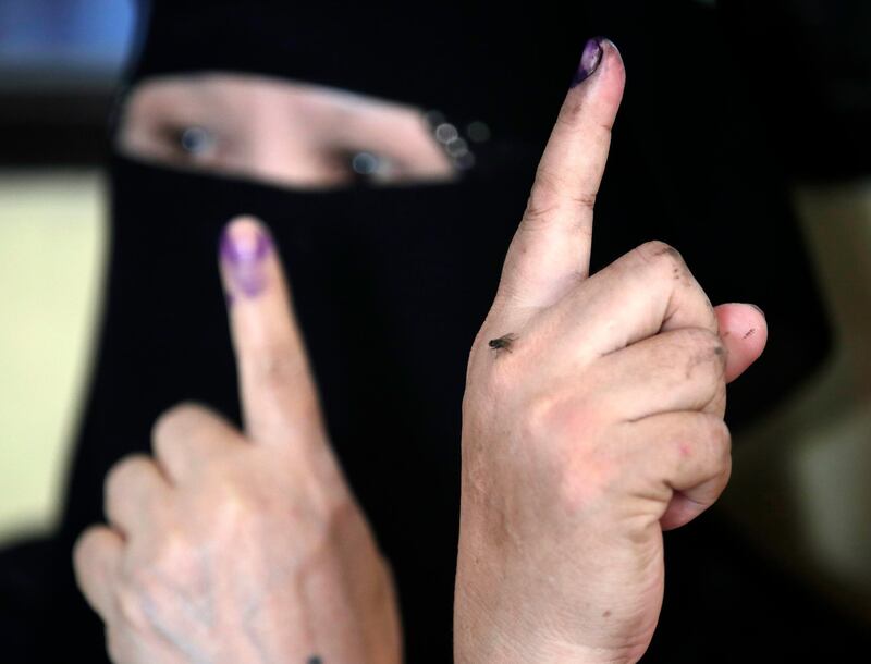 Filipino Muslim women display their fingers marked with indelible ink after voting at an elementary school turned into a voting precinct in Manila, Philippines.  EPA