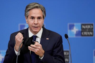 FILE PHOTO: U.S. Secretary of State Antony Blinken removes his mask as gives a press briefing at the end of a NATO Foreign Ministers' meeting at the Alliance's headquarters in Brussels, Belgium, March 24, 2021. Olivier Hoslet/Pool via Reuters/File Photo