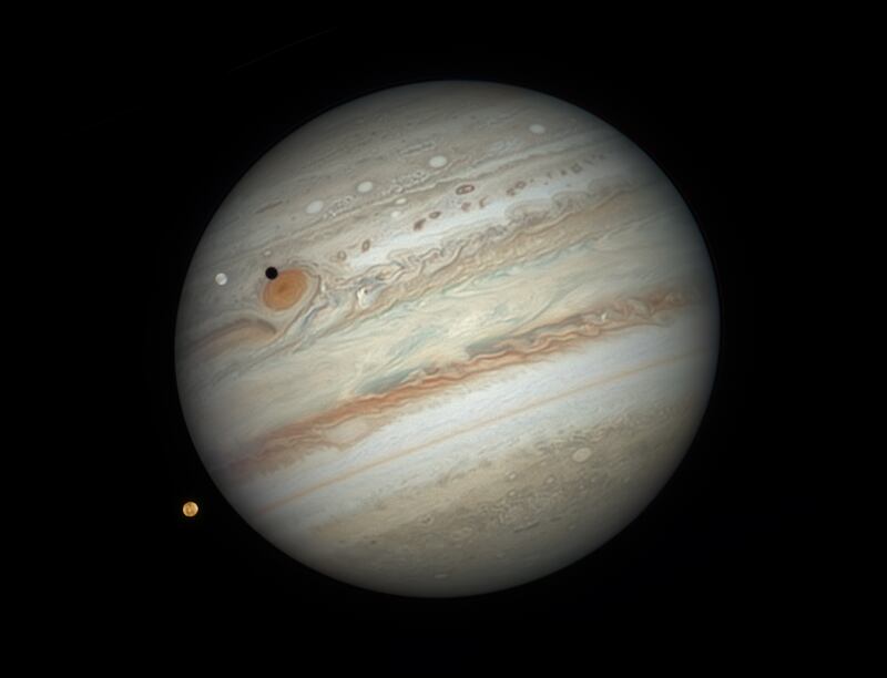 Jupiter flanked by two of its moons, Io and Europa. Photo: Damian Peach