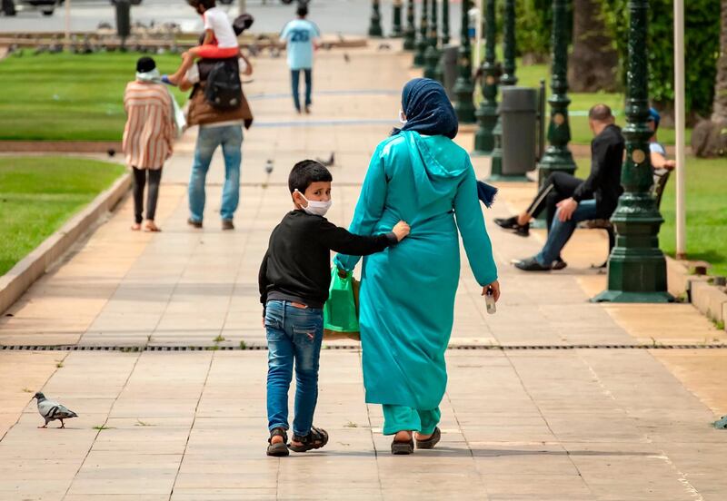 A mother walks with her son in the centre of Morocco's capital Rabat amid the ongoing Covid-19 pandemic. AFP
