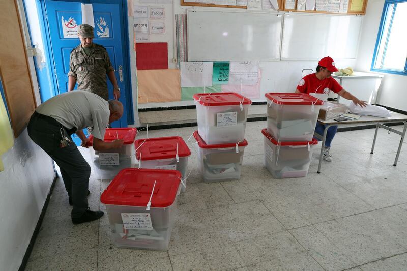 Workers of Tunisia's Independent High Election Authority (ISIE) are putting ballot boxes  in the polling station ahead of tomorrow's presidential election in Tunis, Tunisia. EPA