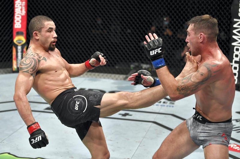 ABU DHABI, UNITED ARAB EMIRATES - JULY 26: (L-R) Robert Whittaker of New Zealand kicks Darren Till of England in their middleweight fight during the UFC Fight Night event inside Flash Forum on UFC Fight Island on July 26, 2020 in Yas Island, Abu Dhabi, United Arab Emirates. (Photo by Jeff Bottari/Zuffa LLC via Getty Images)