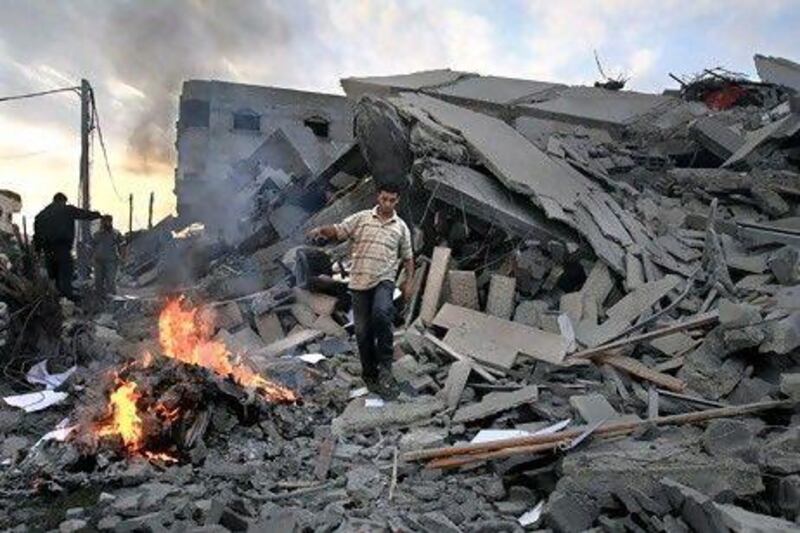 A Hamas security member inspects the destroyed office building of Hamas prime minister Ismail Haniyeh in Gaza City.