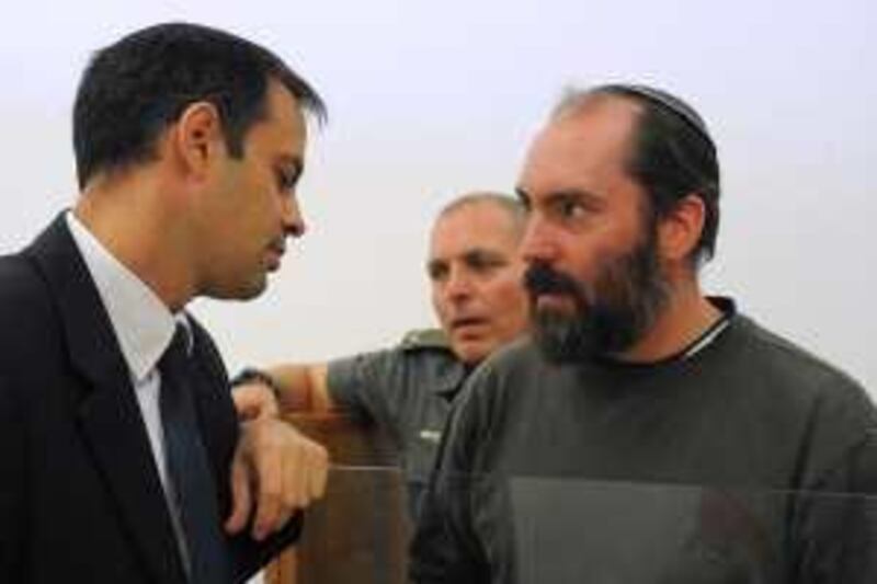 Ultra-Orthodox West Bank settler Jack Teitel, 37, right, is seen inside a court in Petah Tikva, Israel, Wednesday, Nov. 4, 2009. Israeli authorities have arrested a Jewish-American extremist suspected of carrying out a series of high-profile hate crimes against Arabs, peace activists and a breakaway Jewish sect. Israel's Shin Bet security service says Jack Teitel, a 37-year-old ultra-Orthodox West Bank settler, is behind the attacks, spanning 12 years. (AP Photo/Reuven Castro, Pool)