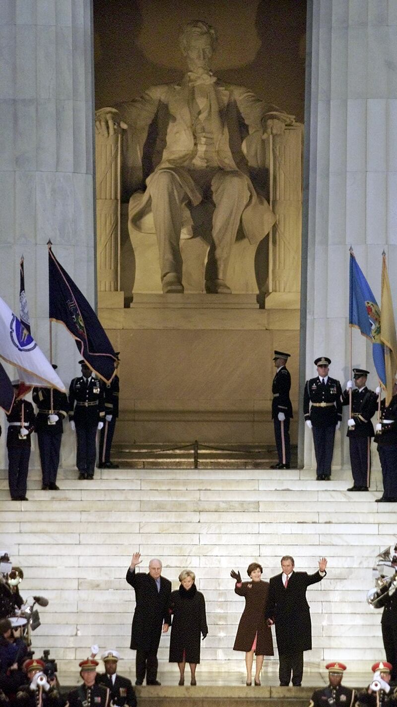 President-elect George W. Bush (R) and his wife Laura Bush with Vice-President-elect Dick Cheney (L) and his wife Lynn wave at the Lincoln Memorial at the opening ceremonies of the inauguration in Washington January 18, 2001. Bush and Cheney will be sworn in on January 20.