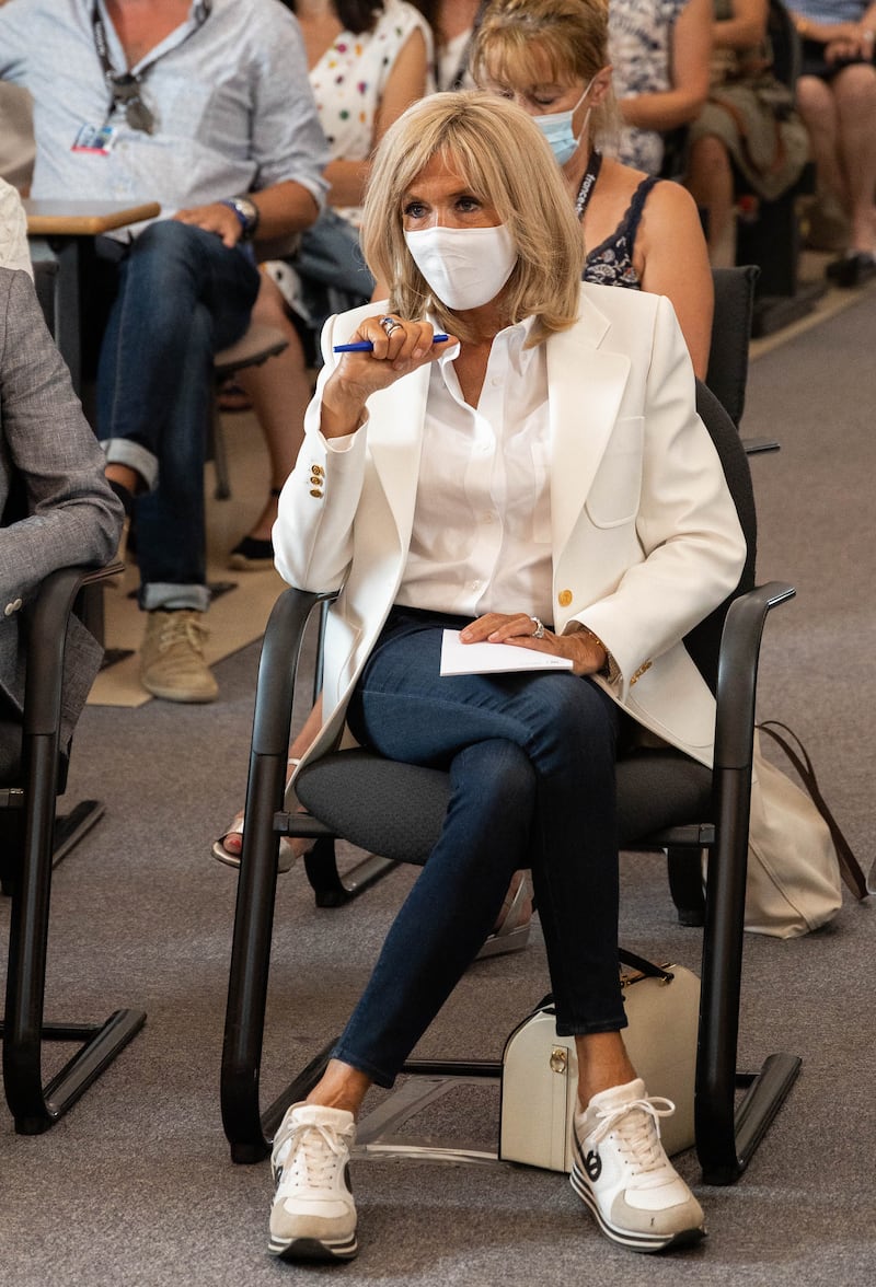 Brigitte, wearing a white shirt and blazer with jeans and trainers, visits Angouleme, on August 25, 2021. AFP