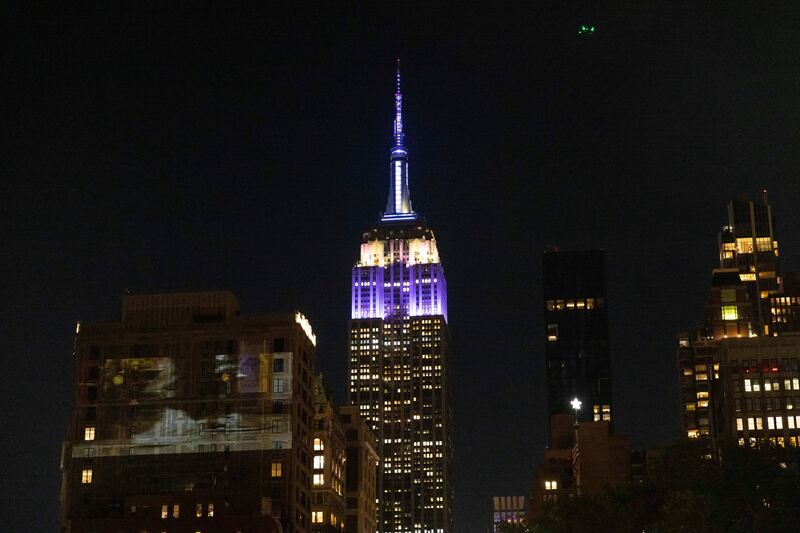 The Empire State Building is lit in purple and silver in celebration of the life of the late queen. AP
