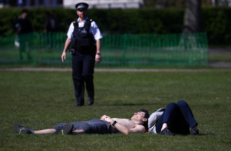 A Police officer with people in Greenwich Park, as the spread of the coronavirus disease (COVID-19) continues, London, Britain. REUTERS