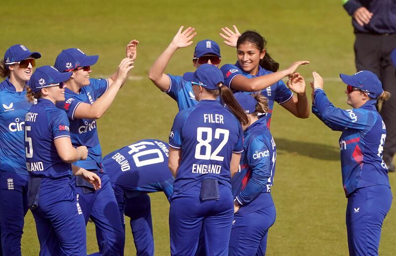Mahika Gaur, second right, celebrates with teammates after taking the wicket of Anushka Sanjeewani during the first ODI between England and Sri Lanka. PA