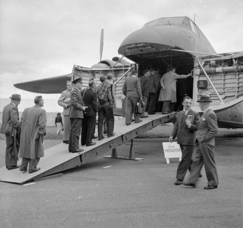 Visitors queue to have a look inside a Bristol freighter at the 1956 Farnborough Airshow.