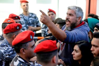 A Lebanese man argues with security forces by a barrier near parliament headquarters in Beirut. AFP