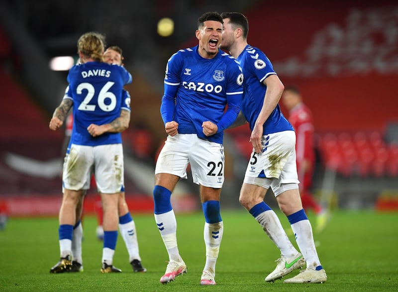 LIVERPOOL, ENGLAND - FEBRUARY 20: Ben Godfrey and Michael Keane of Everton celebrate following their team's victory in the Premier League match between Liverpool and Everton at Anfield on February 20, 2021 in Liverpool, England. Sporting stadiums around the UK remain under strict restrictions due to the Coronavirus Pandemic as Government social distancing laws prohibit fans inside venues resulting in games being played behind closed doors. (Photo by Paul Ellis - Pool/Getty Images)