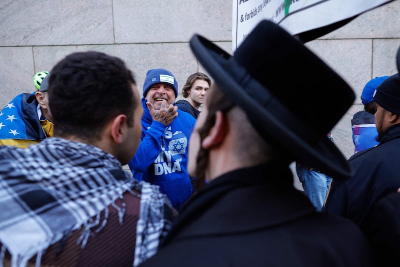 Supporters of Israel, in the background, argue with pro-Palestinian Orthodox Jewish men as they demonstrate outside Columbia University, as pro-Palestinian protests continue on the campus in New York. AFP