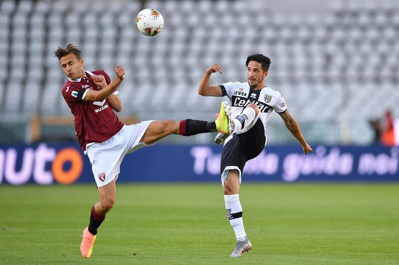 Simone Edera (L) of Torino FC clashes with Matteo Scozzarella of Parma. Getty Images