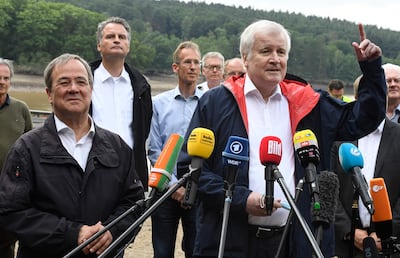 Armin Laschet, left, and German Interior Minister Horst Seehofer visit a dam in Euskirchen, Germany. AFP 