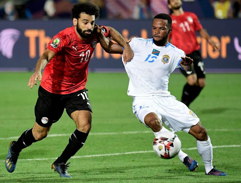 Egypt forward Mohamed Salah, left, fights for the ball with DR Congo's Elia Meschak. AFP