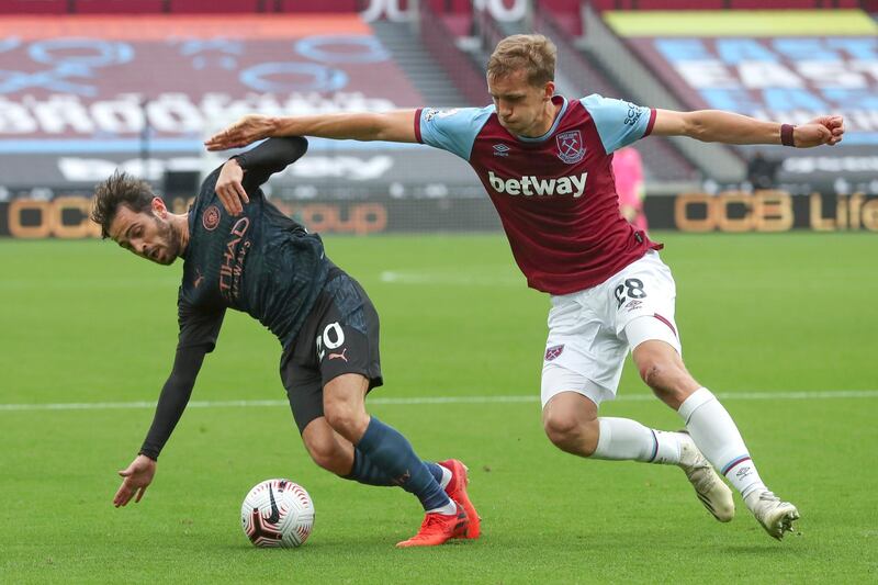 Manchester City's Bernardo Silva holds off the challenge of Tomas Soucek of West Ham. AP