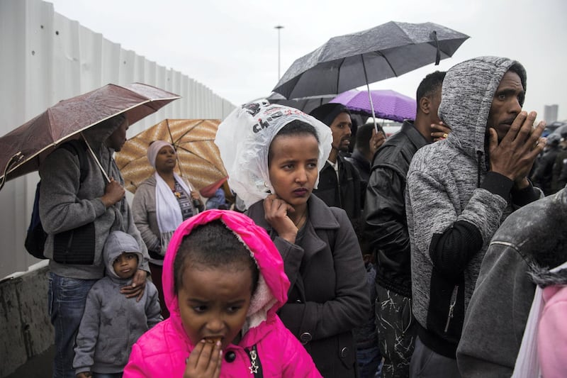 African asylum seekers from Eritrea wait in the rain without any shelter outside the Israeli Ministry of Interior to renew their visas or to apply for asylum in Bnei Brak,Israel on February 26,2018.
Thousands of African asylum seekers have been protesting against Israel's new policy of prison or deportation for migrants.
(Photo by Heidi Levine/Sipa Press).