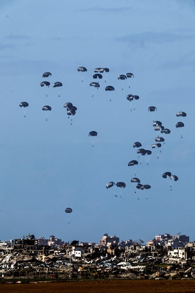Aid packages dropped into northern Gaza on Thursday, as seen from southern Israel.  Reuters