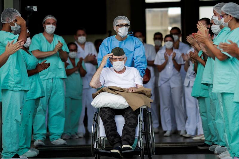 Brazilian 99-year-old former WWII combatant Ermando Armelino Piveta gestures as he leaves the Armed Forces Hospital, after being treated for the coronavirus disease in Brasilia, Brazil. Reuters