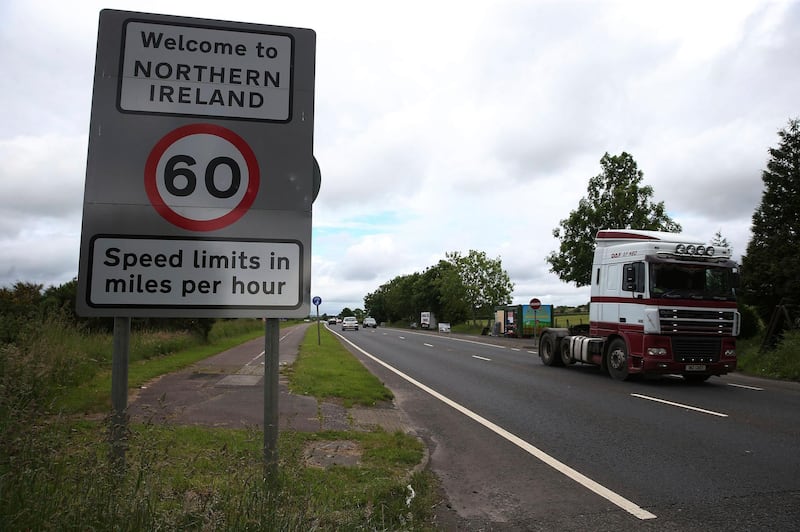 FILE - This is a June 15, 2016  file photo of  of traffic crossing the border between the Republic of Ireland and Northern Ireland in the village of Bridgend, Co Donegal Ireland. Britain said Wednesday Aug. 16, 2017 that there must be no border posts between Northern Ireland and the Irish republic after Brexit.  (Brian Lawless/PA, File via AP)
