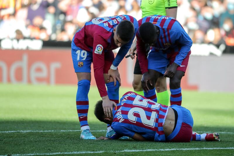 Barcelona's Pierre-Emerick Aubameyang lies on the ground injured. AFP