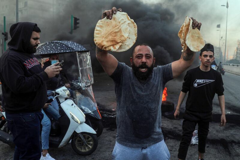 A demonstrator holds government subsidized bread during a protest in Beirut, Lebanon, on Tuesday, March 2, 2021. Lebanon's annual inflation rate reached a record high and food prices soared by up to 400% in December, highlighting the dramatic impact on consumers and businesses of the country's worst financial crisis in decades. Hasan Shaaban/Bloomberg