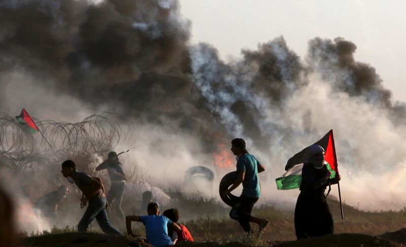 Protesters burn tires near the fence of the Gaza Strip border with Israel during a protest east of Gaza City. AP Photo