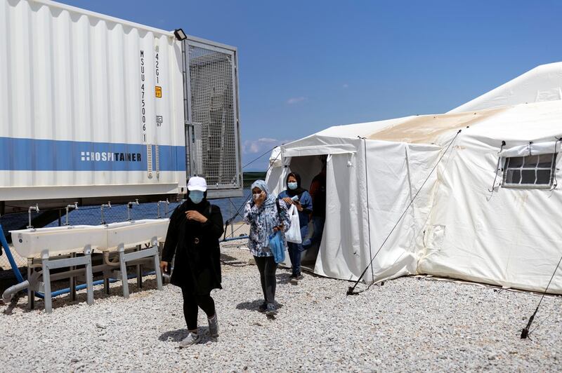 Migrants from Afghanistan leave the waiting area after receiving a vaccine in the Mavrovouni camp. Reuters