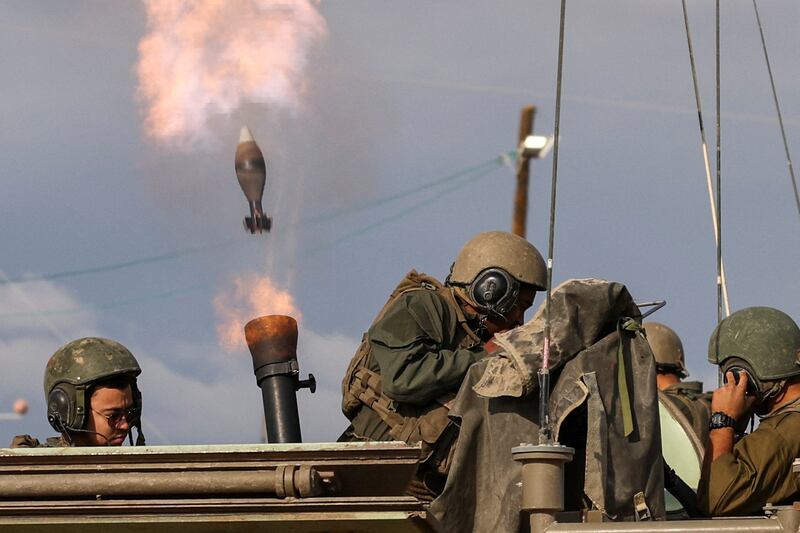 Israeli soldiers fire mortar shells near their border with Gaza on Wednesday. Reuters