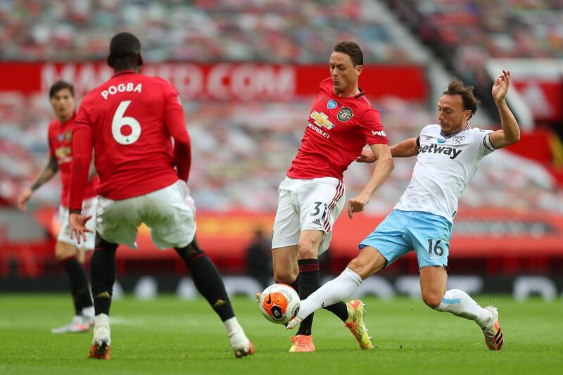 West Ham United's Mark Noble, right, vies with Manchester United's Serbian midfielder Nemanja Matic. AFP