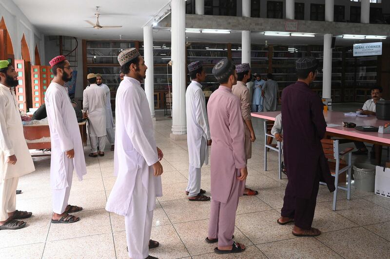 Students wait to receive the CanSino Biologics Covid-19 vaccine in Peshawar. AFP