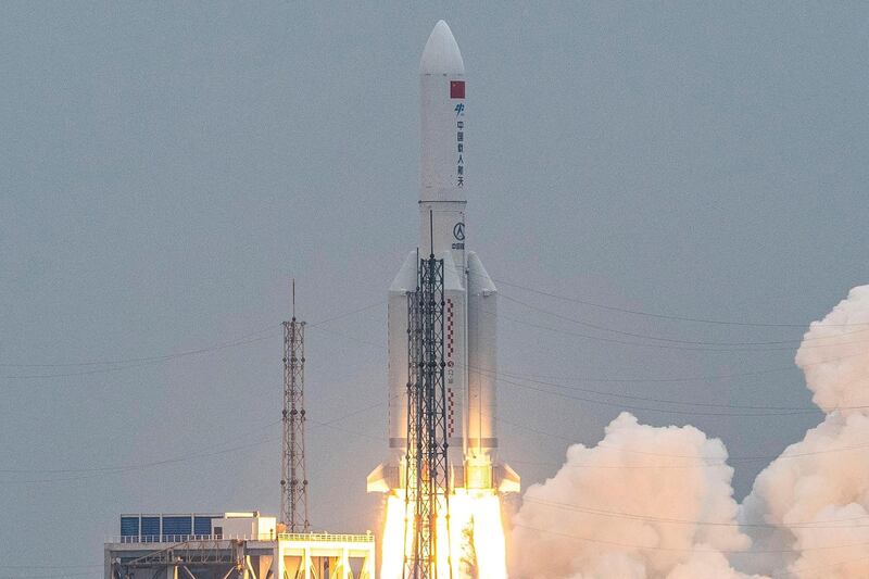 (FILES) This file photo taken on April 29, 2021 shows a Long March 5B rocket, carrying China's Tianhe space station core module, lifting off from the Wenchang Space Launch Center in southern China's Hainan province. A large segment of China's Long March 5B rocket is expected to make an uncontrolled re-entry into the Earth's atmosphere around 2300 GMT on May 8, 2021, according to the Pentagon, but Beijing has downplayed fears and said there is a very low risk of any damage. - China OUT
 / AFP / STR

