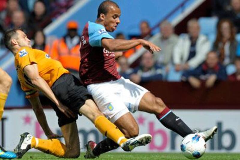 Aston Villa's Gabriel Agbonlahor, right, shoots under pressure from Roger Johnson.