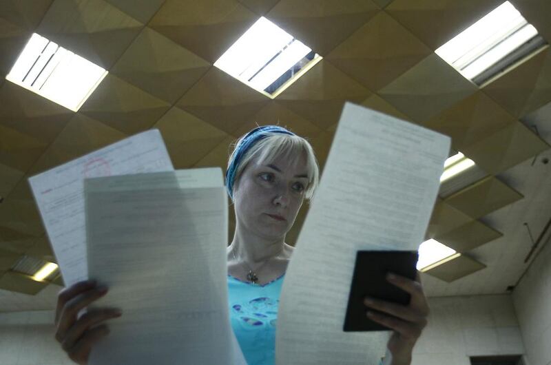 A woman studies her ballot paper during voting in a presidential election at a Kiev polling station on May 25, 2014.  David Mdzinarishvili/Reuters