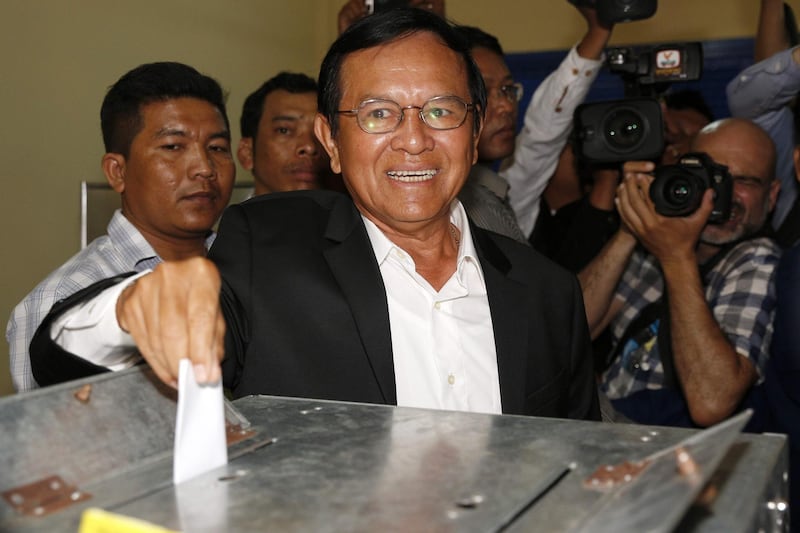 (FILES) This file photo taken on June 04, 2017 shows Kem Sokha, leader of the Cambodia National Rescue Party (CNRP), casting his ballot at a polling station in Phnom Penh during the June 2017 local elections where the opposition made significant gains. - Cambodia opposition leader Kem Sokha was denied bail on August 22, 2018 after almost a year in jail on treason charges that critics say were trumped up by premier Hun Sen to gift himself a free run in last month's election. (Photo by STR / AFP)