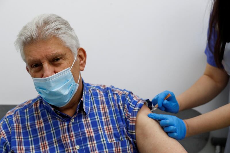 FILE PHOTO: An elderly person receives a dose of the Oxford/AstraZeneca COVID-19 vaccine at Cullimore Chemist, in Edgware, London, Britain January 14, 2021. REUTERS/Paul Childs/File Photo