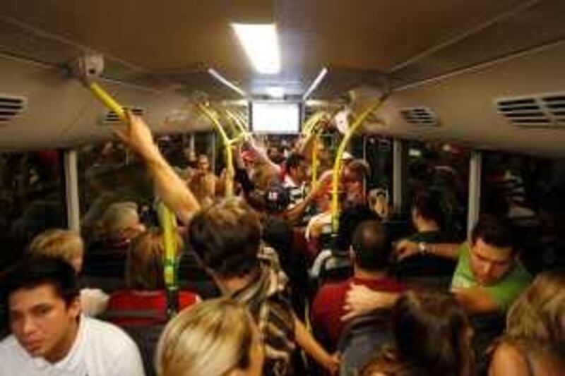 Abu Dhabi - October 30, 2009:  People ride a bus heading to designated parking lots on  the second day of the FORMULA 1» ETIHAD AIRWAYS ABU DHABI GRAND PRIX on Yas Island. ( Philip Cheung / The National )


 *** Local Caption ***  PC00036-YasBusses.jpg