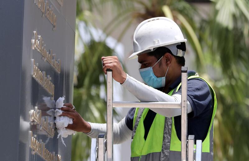DUBAI, UNITED ARAB EMIRATES , June 11 – 2020 :- Worker wearing protective face mask during the hot and humid weather outside the Emirates NBD branch on Al Wasl road in Dubai. (Pawan Singh / The National) For News/Standalone/Online/Stock