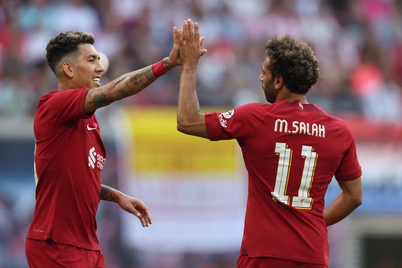 Mohamed Salah celebrates with Roberto Firmino after scoring Liverpool's first goal. Getty