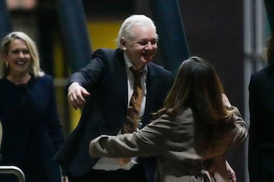 WikiLeaks founder Julian Assange embraces his wife Stella after landing at RAAF air base Fairbairn in Canberra. AP 