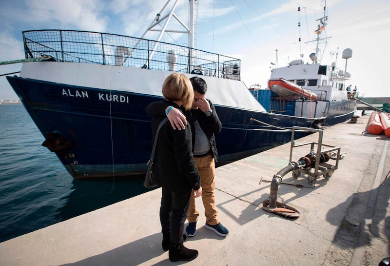 Abdullah Kurdi and his siter Tima react in front of a Sea-Eye rescue boat named after his son and her nephew Alan Kurdi during its inauguration in Palma de Mallorca on February 10,  2019.  The former research vessel "Professor Albrecht Penck" was rebaptised "Alan Kurdi", after the Syrian boy who was drowned during a ship wreck in the Mediterranean Sea. / AFP / JAIME REINA
