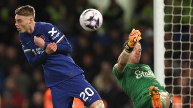 Chelsea's Cole Palmer, left, challenges for the ball with Everton's goalkeeper Jordan Pickford during the English Premier League soccer match between Chelsea and Everton at Stamford Bridge stadium in London, Monday, April 15, 2024.  (AP Photo / Ian Walton)