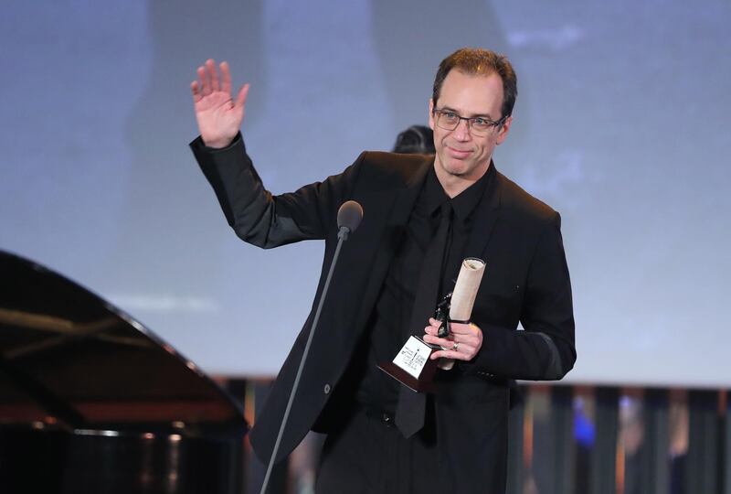 Mexican Director Jorge Cuchi holds the Naguib Mahfouz Award for Best Screenplay for the film '50 or Two Whales Meet on the Beach' during the closing ceremony of the 42nd Cairo International Film Festival (CIFF). EPA