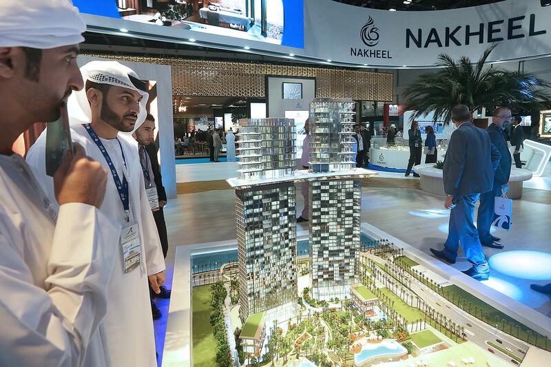 Above, visitors at the stand of Nakheel, which is showcasing the Palm 360 project on Dubai’s Palm Jumeirah. Satish Kumar / The National