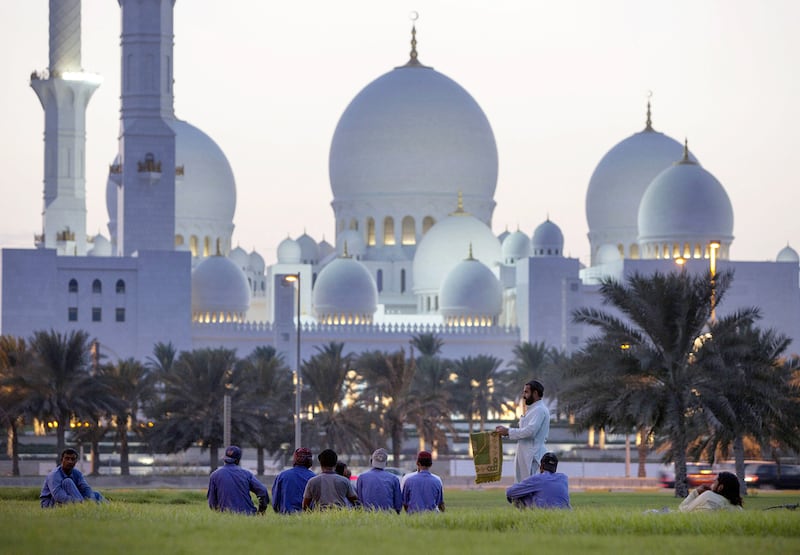 Workers enjoy the view of Sheikh Zayed Grand Mosque in October 2014. Silvia Razgova / The National