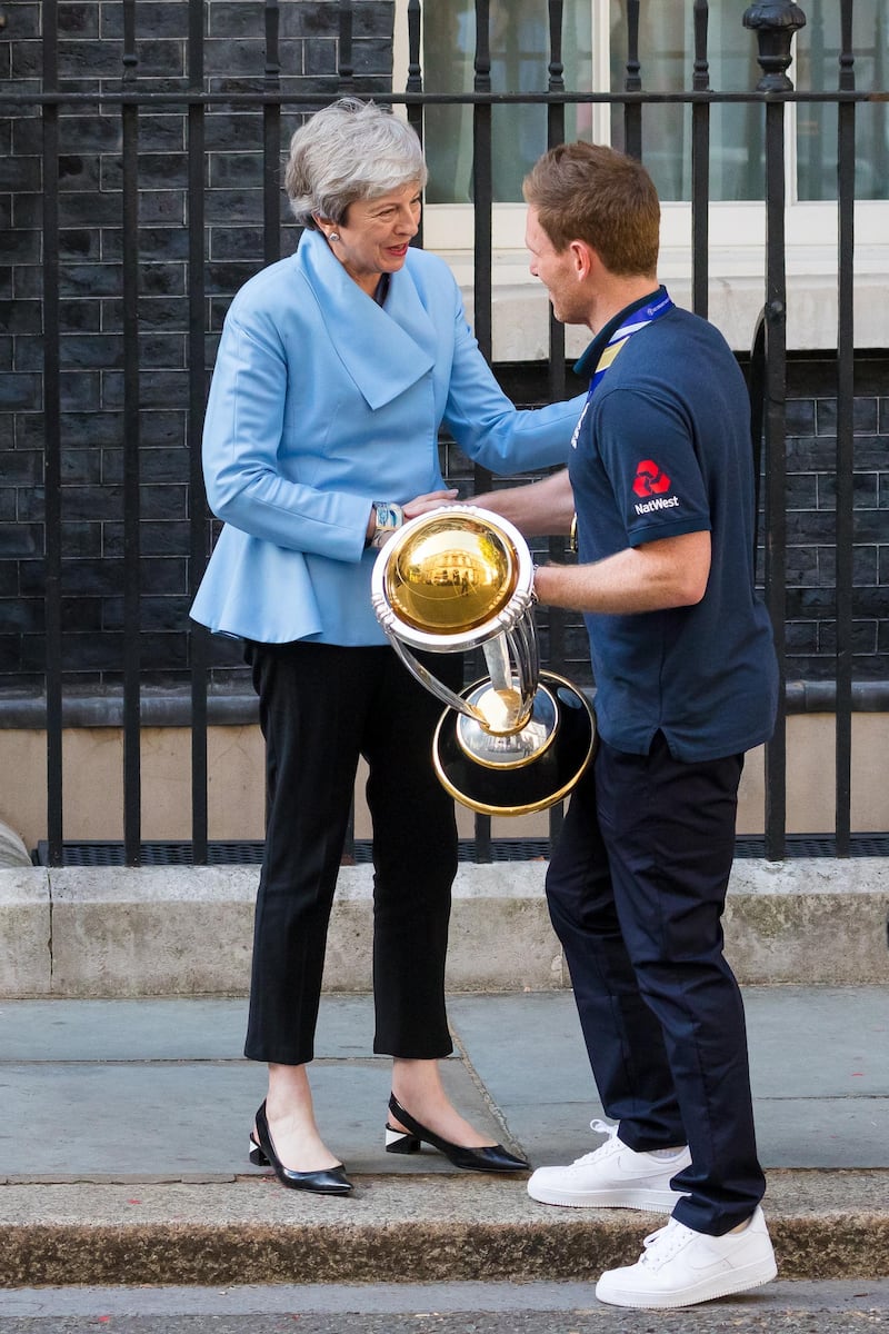 British prime minister Theresa May greets England captain Eoin Morgan as he arrives in Downing Street with the World Cup trophy. EPA