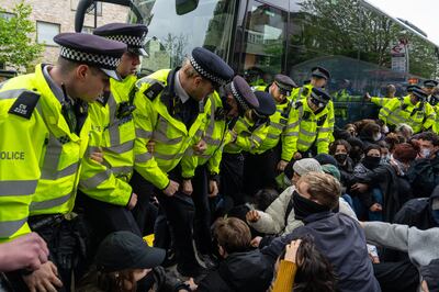 Police recently scuffled with protesters in south London who were blocking a bus being used to transport migrants. Getty Images 