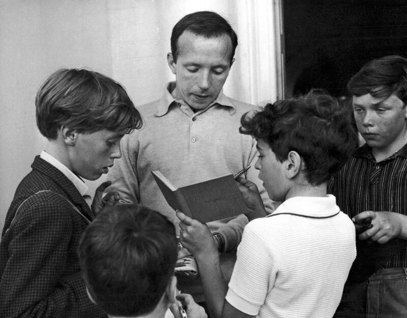 Nobby Stiles, the England soccer player, signs autographs for young fans outside the England team's hotel in Hendon, London. AP